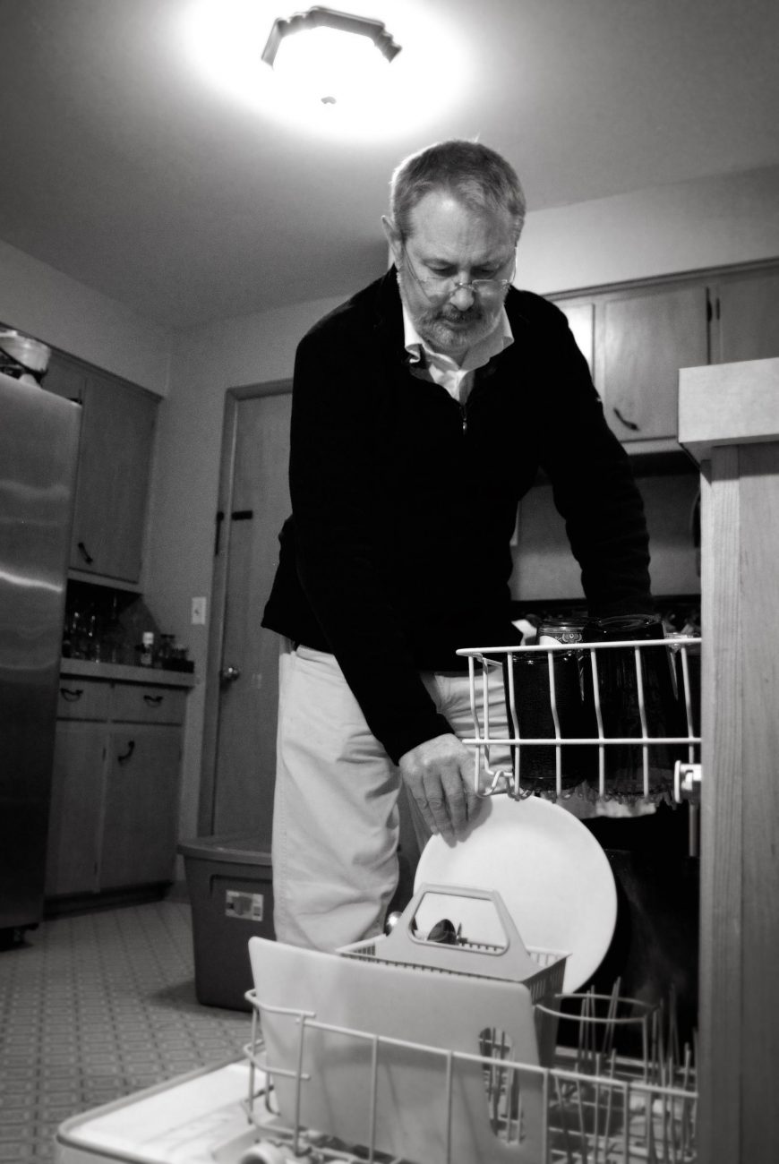Stacking the dishwasher by Gary Allman